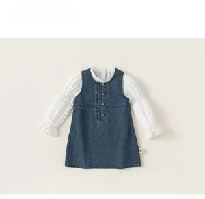 Detailed flat lay of girl's blue denim vest dress and white ruffled shirt set