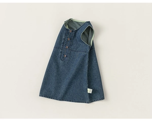Detail view of girls denim sleeveless dress with front brown buttons and A-line cut