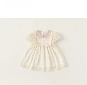 Detail of pink Peter Pan collar and bow decoration on beige girls summer dress