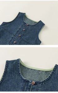 Detailed macro shot of the light green inner neckline trim on a navy blue denim vest
