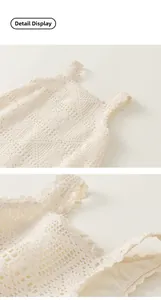 Close-up detail of cream crochet lace children dress with delicate wave lace edging