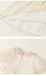 Detail of baby girl cream dress showing Peter Pan collar and back zipper construction