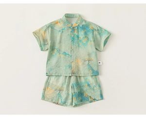Flat lay of boys traditional Chinese set with mountain print and frog button closure