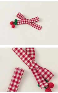 Detail of red gingham bow hair clip with handmade crochet cherry pendants for girls
