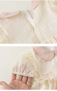 Detail of baby girl princess dress with pink bow, sequined fabric and invisible zipper