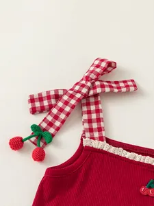 Sweet red knitted girl top with gingham bow straps and delicate crochet cherry accents