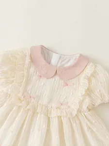 Pink Peter Pan collar baby girl dress with bow detail and ruffled sleeves in cream white