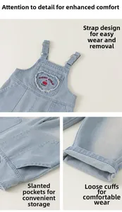 Detail of denim overalls for girls with heart-shaped cherry embroidery and side pockets