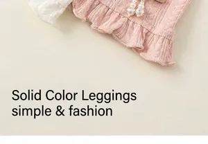 Detail of pink and white knitted leggings featuring cable texture and ruffled pearl cuffs