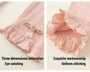 Detail of pink knitted leggings featuring delicate ruffled cuffs and pearl bead accents