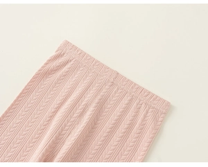 Detailed close-up of light pink ribbed waistband with fine knit texture on toddler pants