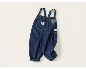 Close-up of deep blue denim overalls featuring a chest pocket and babycity brand label