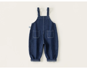 Detail view of dark blue denim overalls with contrast stitching and rolled cuffs