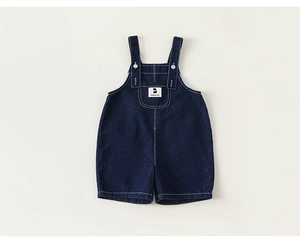 Detail of kids denim overalls with adjustable metal buckles and brand chest pocket