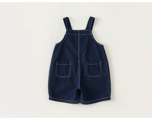 Detail showing back pockets and white stitching on navy blue denim overalls for toddlers