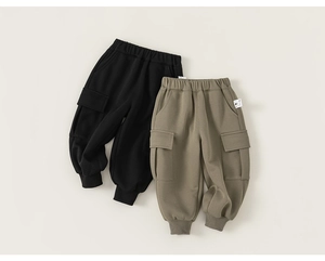 Close-up of kids cargo jogger pants in black and khaki featuring large side flap pockets