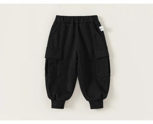 Detail of children's black jogger pants featuring elastic waistband and cargo pockets