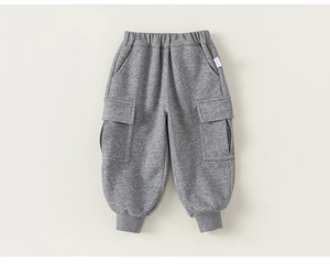 Detail of grey kids' cotton jogger pants featuring cargo pockets and ribbed cuffs