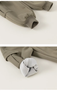 Close-up of olive green kids pants with thick fleece lining and ribbed elastic cuffs