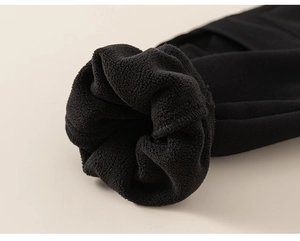 Close-up detail of thickened black fleece lining and fine stitching on boy's thermal pants