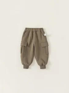 Deep khaki cotton joggers for boys featuring elastic waist and utility cargo side pockets