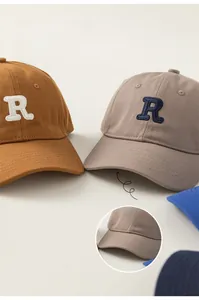 Detail of wide brim kids baseball caps with R embroidery and cotton canvas texture