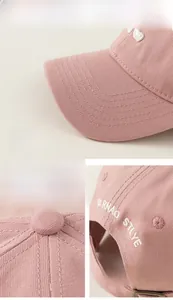 Detail view of pink cotton baseball cap featuring neat stitching and metal buckle