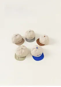 Detail showing five color variants of summer baby baseball caps with GOOD DAY embroidery