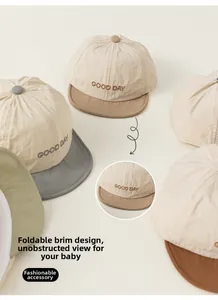 Detail showing the foldable soft brim design and GOOD DAY embroidery on a baby sun hat