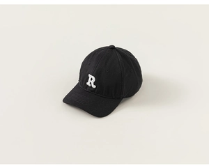 Detailed close-up of a black cotton kids baseball cap featuring white 3D letter R embroidery