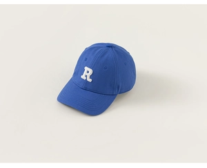 Detail shot of royal blue cotton baseball cap with 3D white letter R embroidery