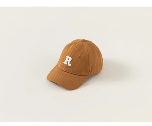 Detail of caramel brown kids baseball cap featuring 3D white embroidered R logo