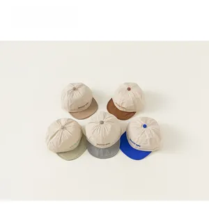 Flat lay of five color-blocked baby baseball caps with GOOD DAY embroidery detail