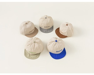 Detail of five soft brim baby caps with GOOD DAY embroidery in various colors