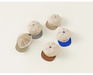 Detail view of cotton baby baseball caps with soft brims and embroidered Good Day text