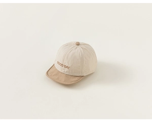 Close-up of baby baseball cap with bicolor patchwork and Good Day embroidery detail