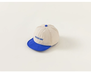 Close-up of GOOD DAY letter embroidery on kids color-block mesh baseball cap