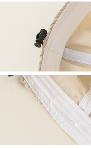Detailed macro view of children's sun hat interior featuring white sweatband and adjustable cord