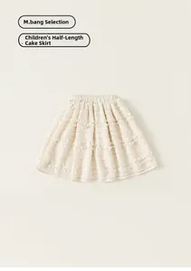 Flat lay of a girls tiered ruffled cake skirt in creamy white with elastic waist