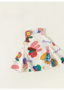 Detailed flat lay of white cotton sleeveless dress with colorful cartoon princess prints