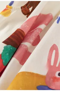 Close-up of soft cotton fabric with cartoon bunny print for toddler summer dress