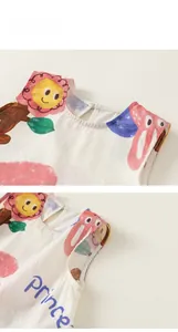 Detail view of child sleeveless dress neckline with sunflower print and button closure