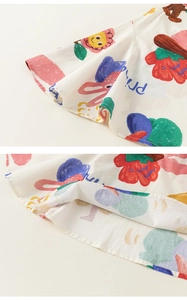 Detailed view of colorful cartoon floral print and fine stitching on cotton fabric