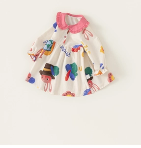 Detailed view of beige girl's dress featuring pink Peter Pan collar and cartoon rabbit prints