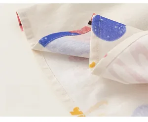 Close-up of fine stitching and sewing detail on cartoon graffiti sleeveless baby dress
