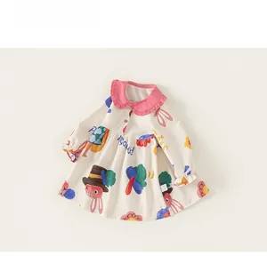 Detail of toddler dress featuring colorful cartoon rabbit prints and pink ruffled neckline
