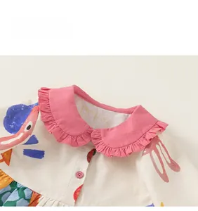 Detail of pink ruffle Peter Pan collar and colorful cartoon prints on kids dress