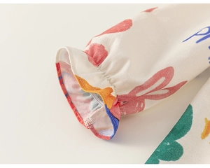 Detail of soft cotton sleeve cuff with elastic frills and colorful cartoon rabbit prints