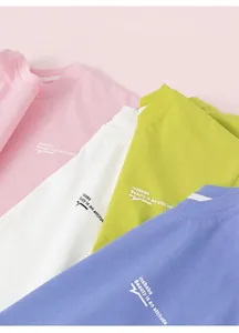 Close-up of pastel cotton T-shirts in pink, white, green and blue with letter print