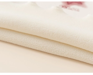 Close-up of soft off-white fleece fabric with red star print and warm texture detail